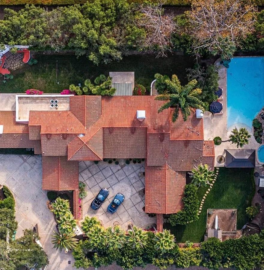 Aerial showing pool, gardens and tile rooflines