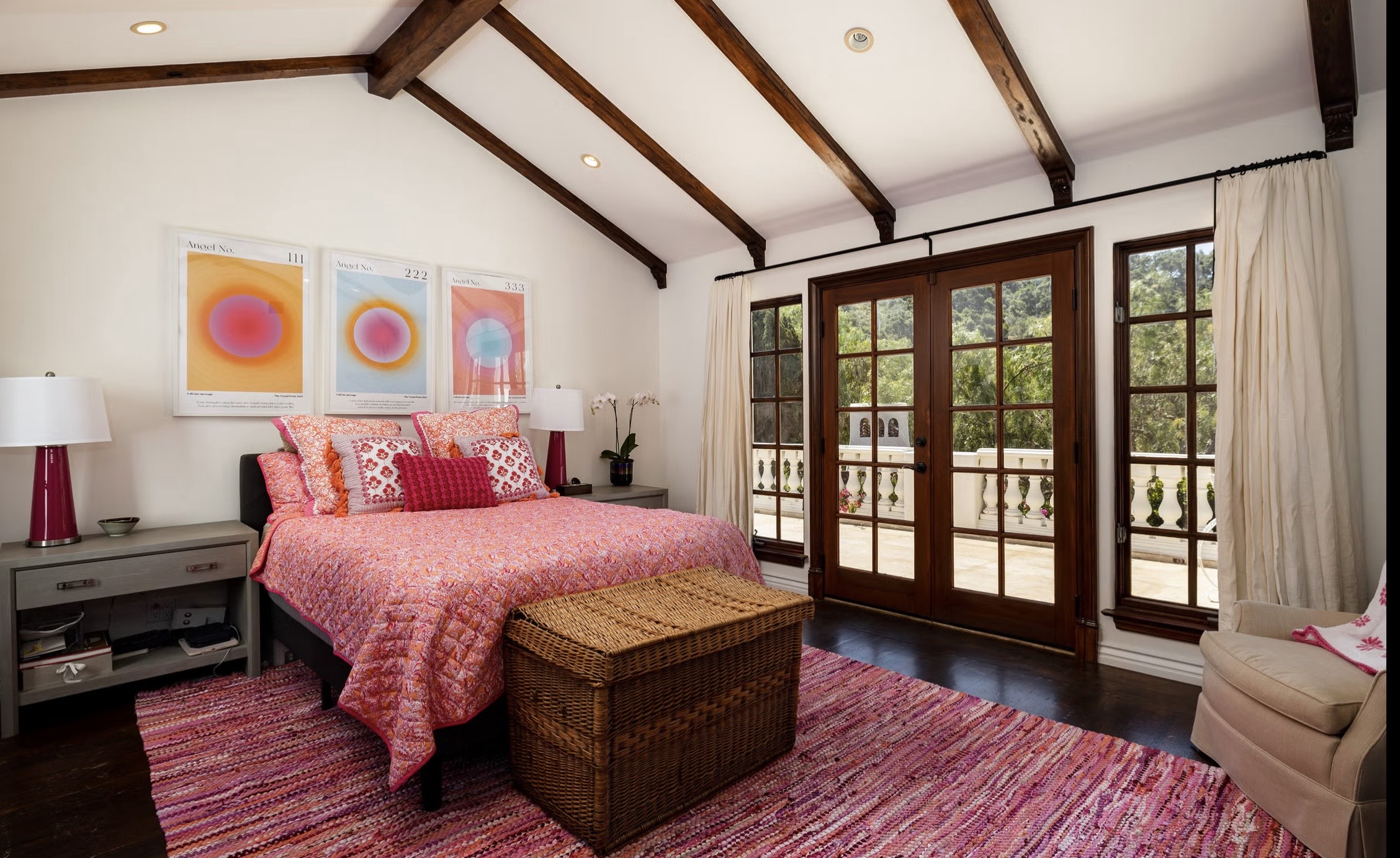 Guest bedroom with exposed beams and arched window