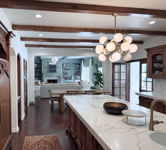Chef's kitchen with dual marble islands and brass fixtures