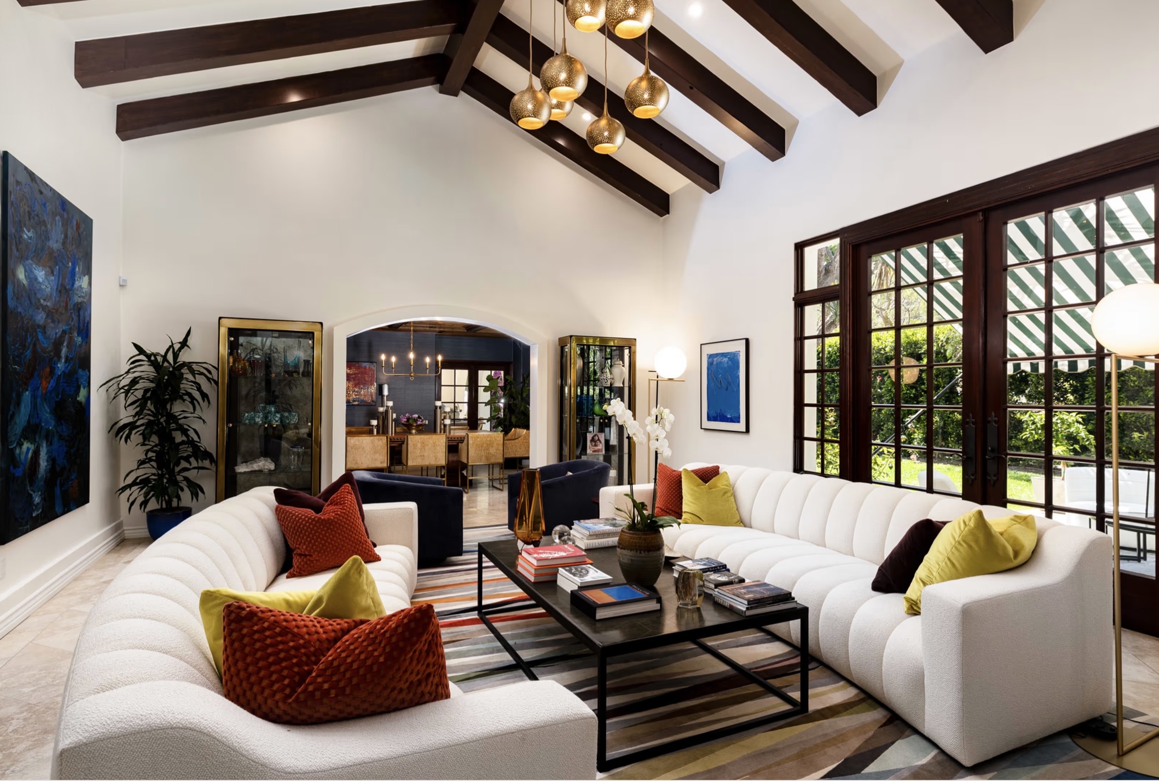 Great room with arched openings and stone fireplace