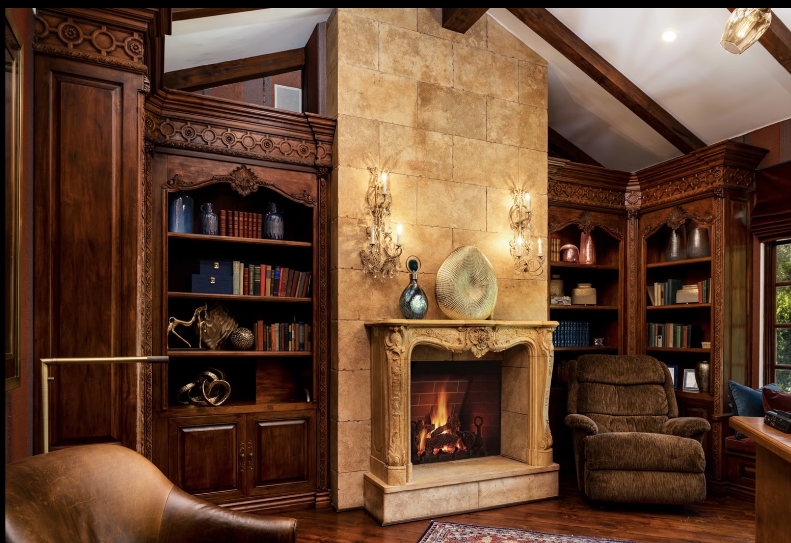 Library with carved fireplace and panelled walls