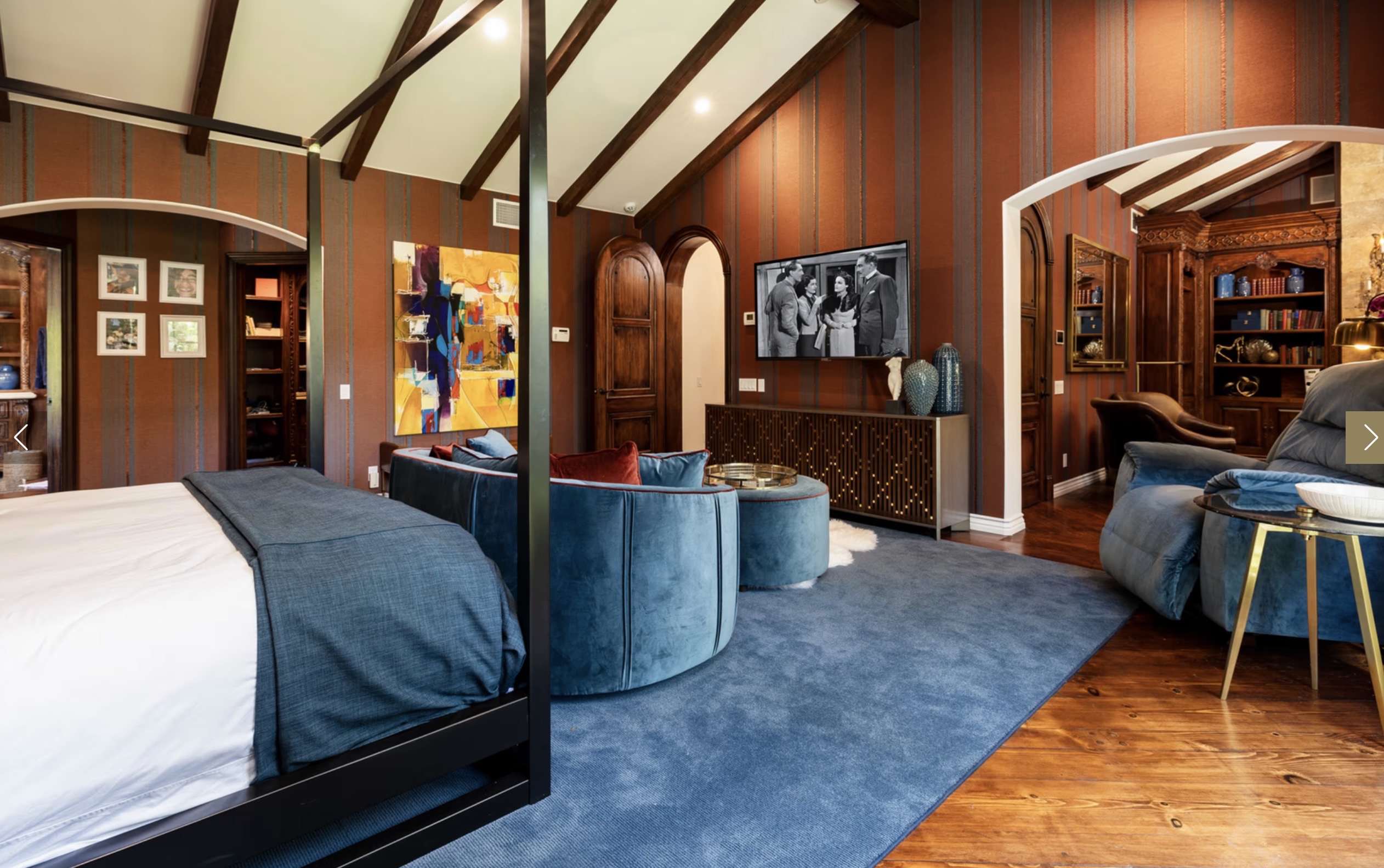 Master suite with arched window and beamed ceiling